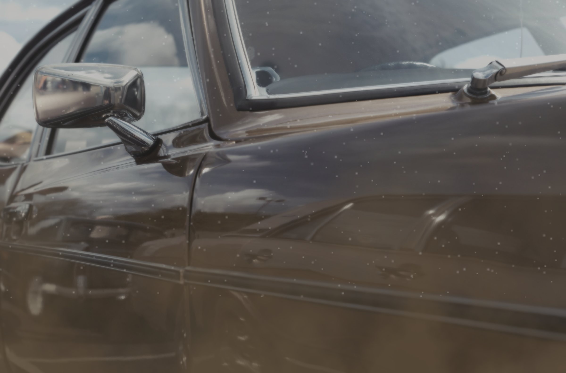 The side of a brown sedan, before