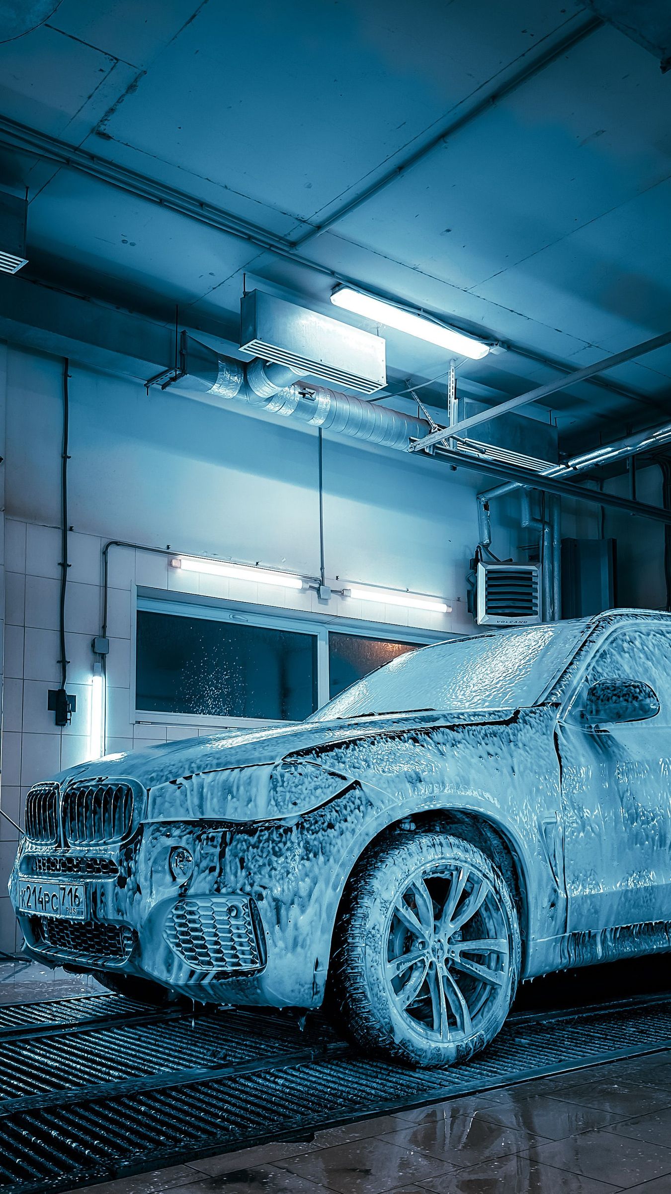 An SUV under snow foam